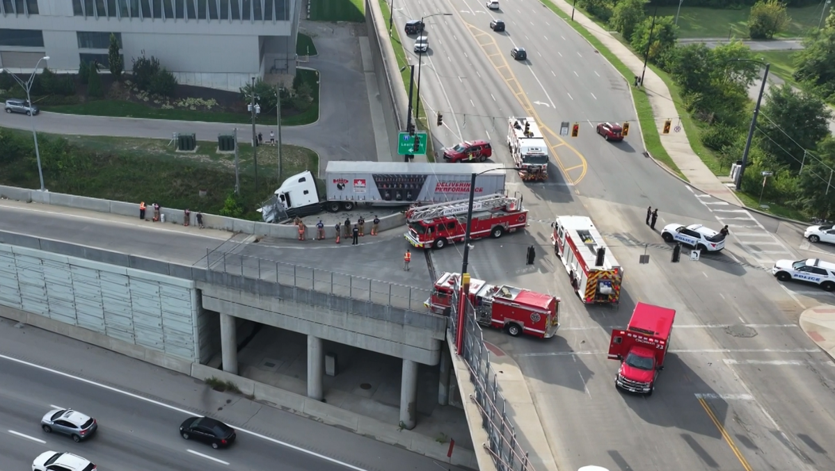 Road reopened after semi-truck hits barrier, dangles over I-71