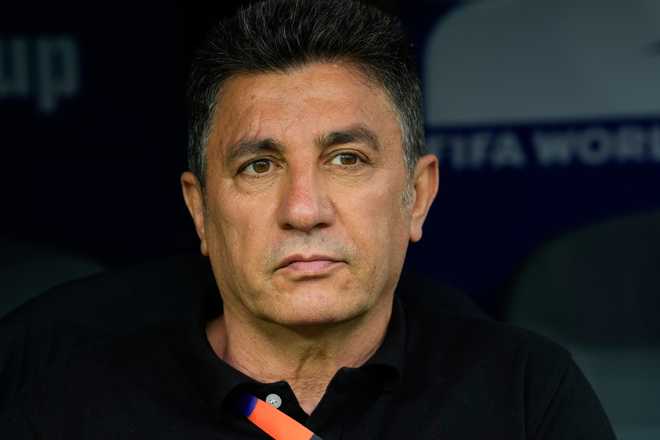 Iran head coach Amir Ghalehnoy sits on the bench prior to the World Cup Group G soccer match between Belgium and Iran in Inglewood, Calif., near Los Angeles, Sunday, June 21, 2026.