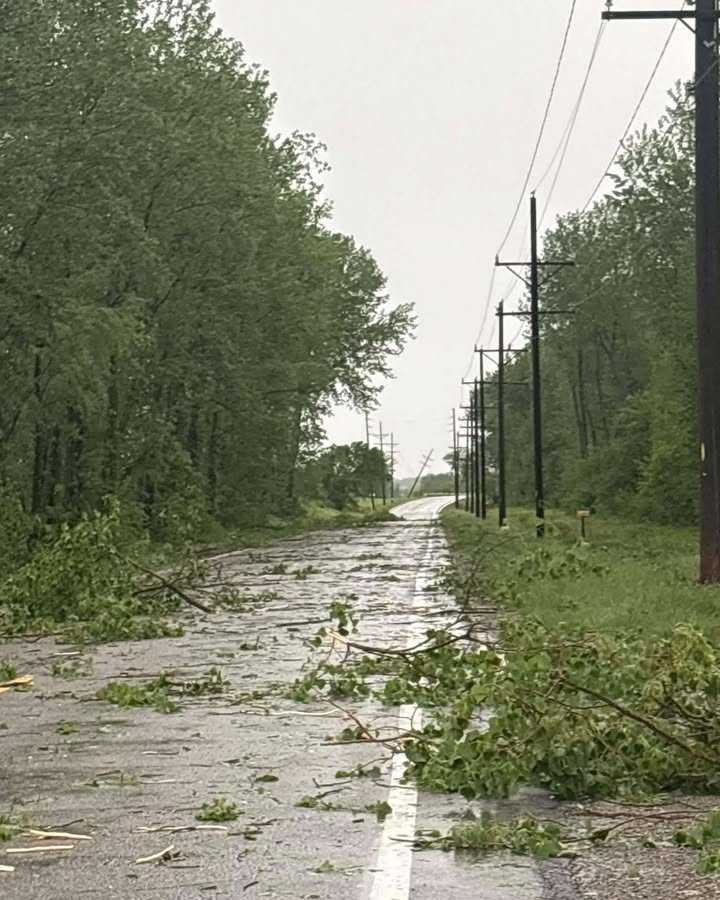 Tree limbs are shown covering a road in Slater, Missouri, after tornado-warned storms on April 27, 2026.