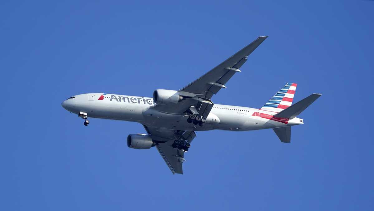 FILE - An American Airlines Boeing 777 is framed by utility wires as it prepares to land at Miami International Airport