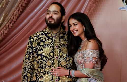 Anant Ambani, son of businessman Mukesh Ambani, poses with his fiance Radhika Merchant on the red carpet during the sangeet ceremony at Jio World Centre, Mumbai, India, in July 2024.