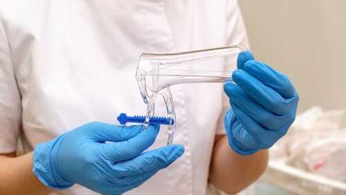 In a traditional screening, a clinician uses a speculum to collect a sample during a pelvic examination