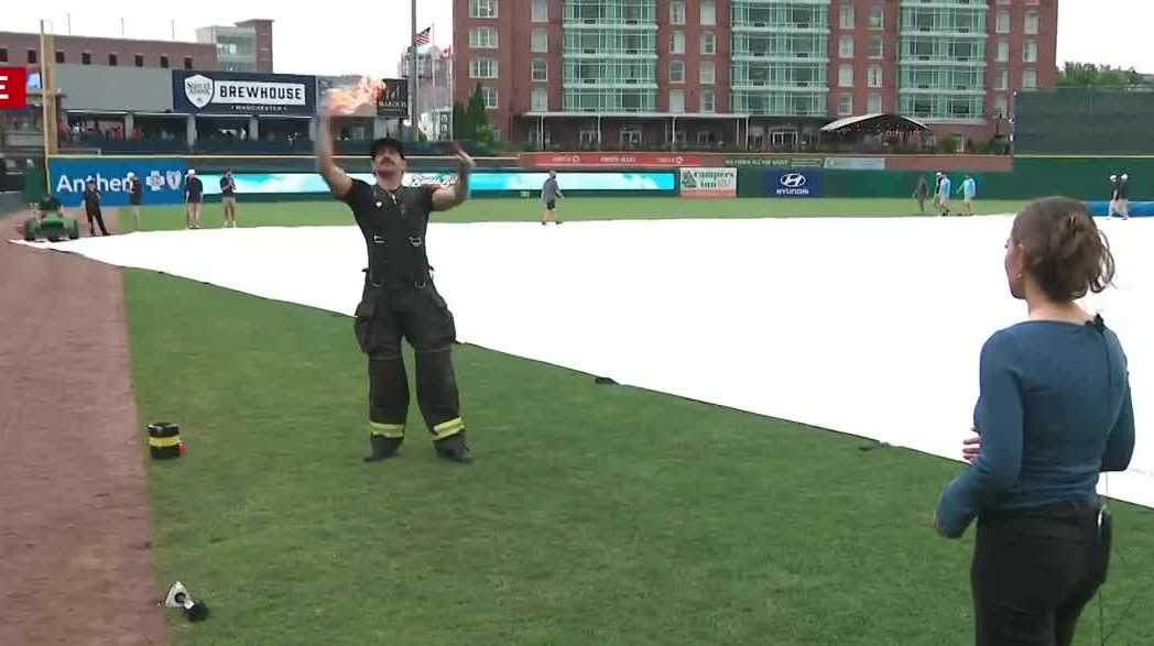 Firefighters pitcher demonstrates fireball before Banana Ball game