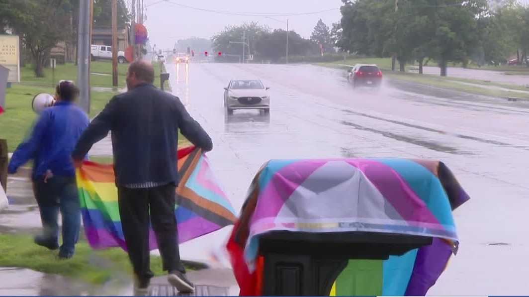 Activists protest church sign in Des Moines during Pride Month