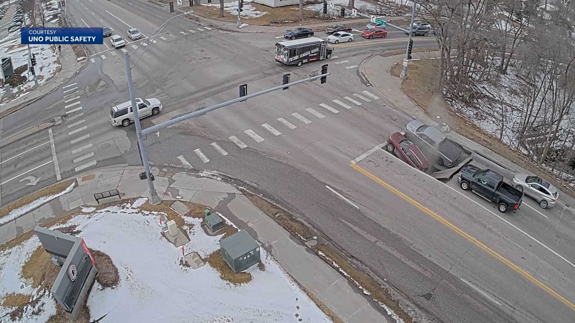 Video captures moment when road 'collapses' leaving two vehicles stuck, Omaha police say