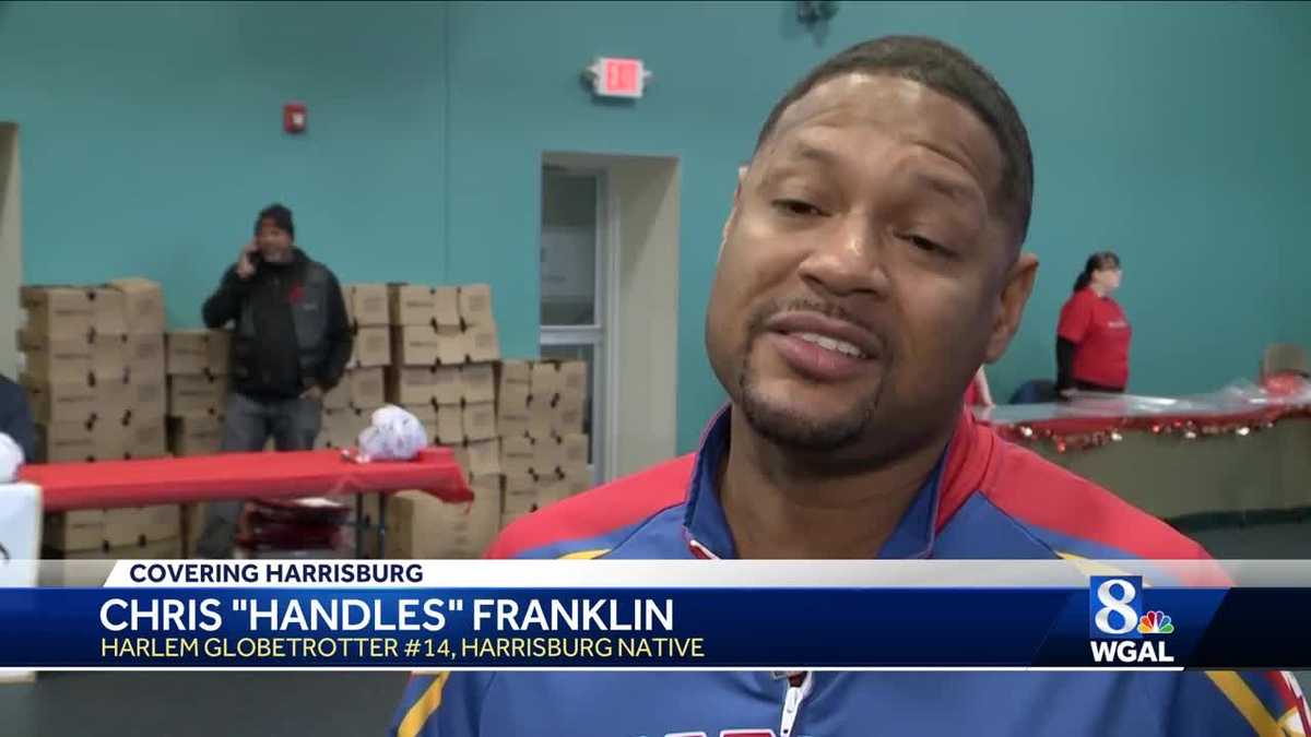 Turkey giveaway assisted by Harrisburg player for Harlem Globetrotters