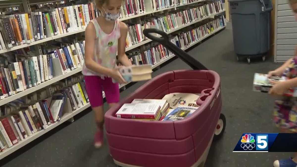 Books are brought to new library, one wagon, at a time