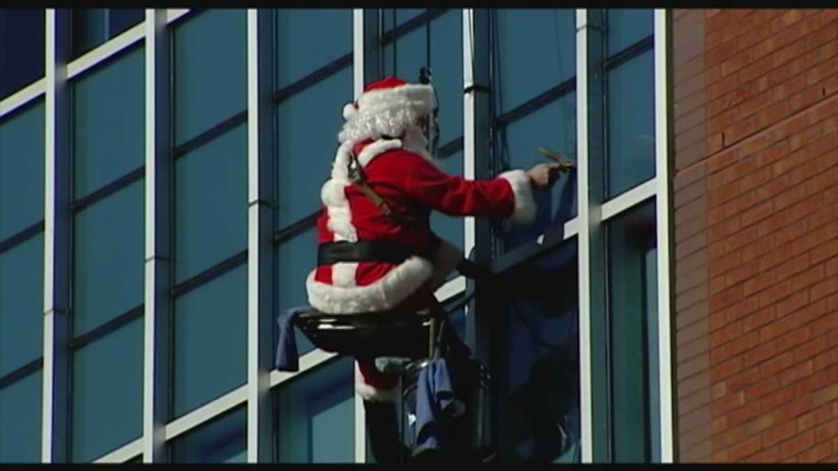 Santa and his elves wash windows at Mission Hospital