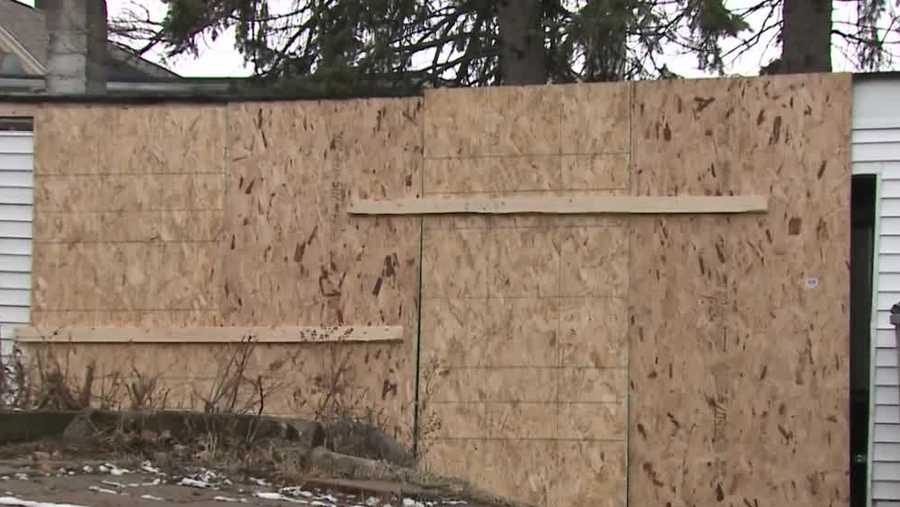 Boarded up building where body was found after fire