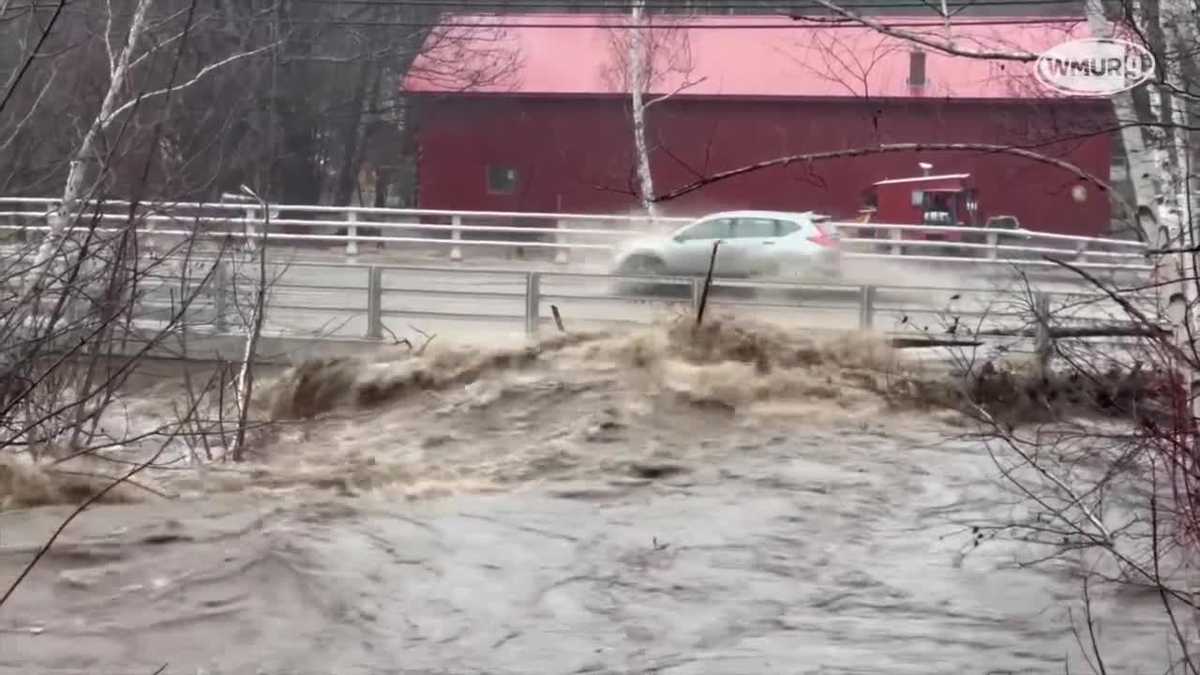 Water rages over bridge in Gorham, NH