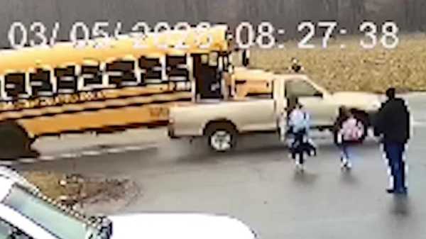 video: truck drives around bus, nearly hits 2 girls