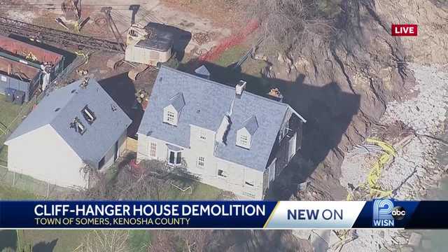 Demolition starts on house dangling