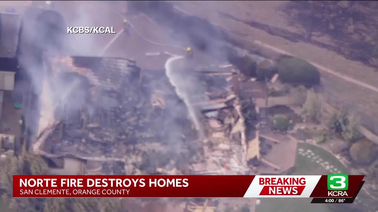 Multiple Southern California homes are ablaze in a fast-moving wildfire fueled by hot, windy weather