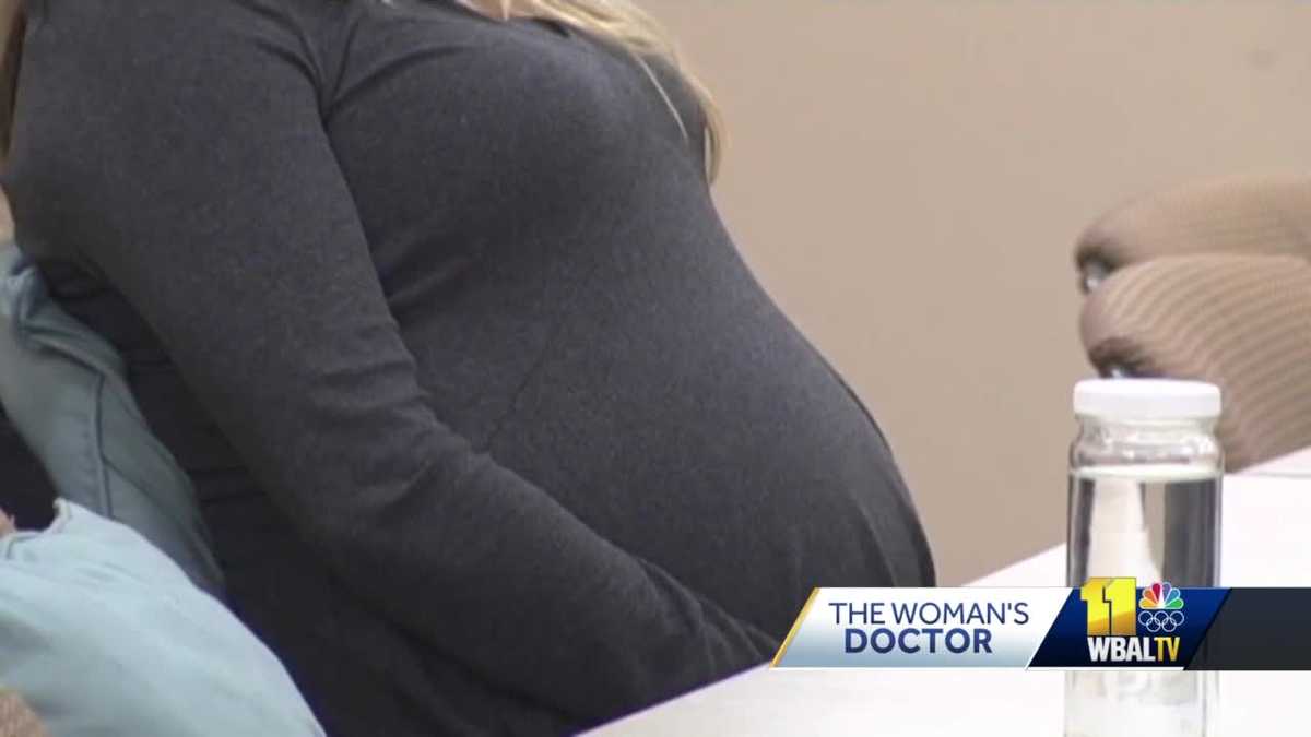 Woman's Doctor Dealing with rib pain from pregnancy