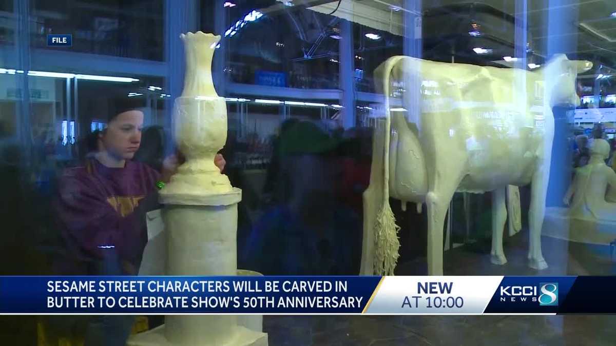 Iowa State Fair butter cow joined by Sesame Street sculptures