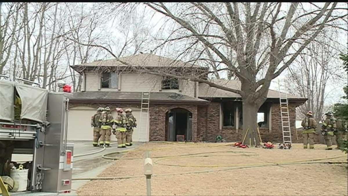 Neighbors help firefighters rescue woman from burning home