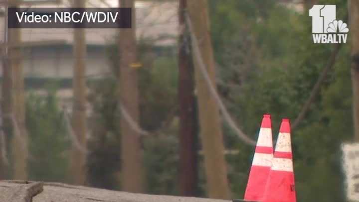 Pressure from partial building collapse causes road to buckle