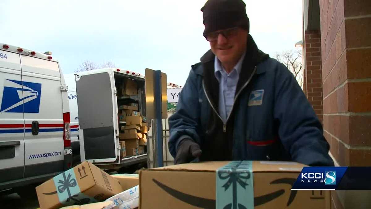 Postal workers dashing through packages to deliver Christmas