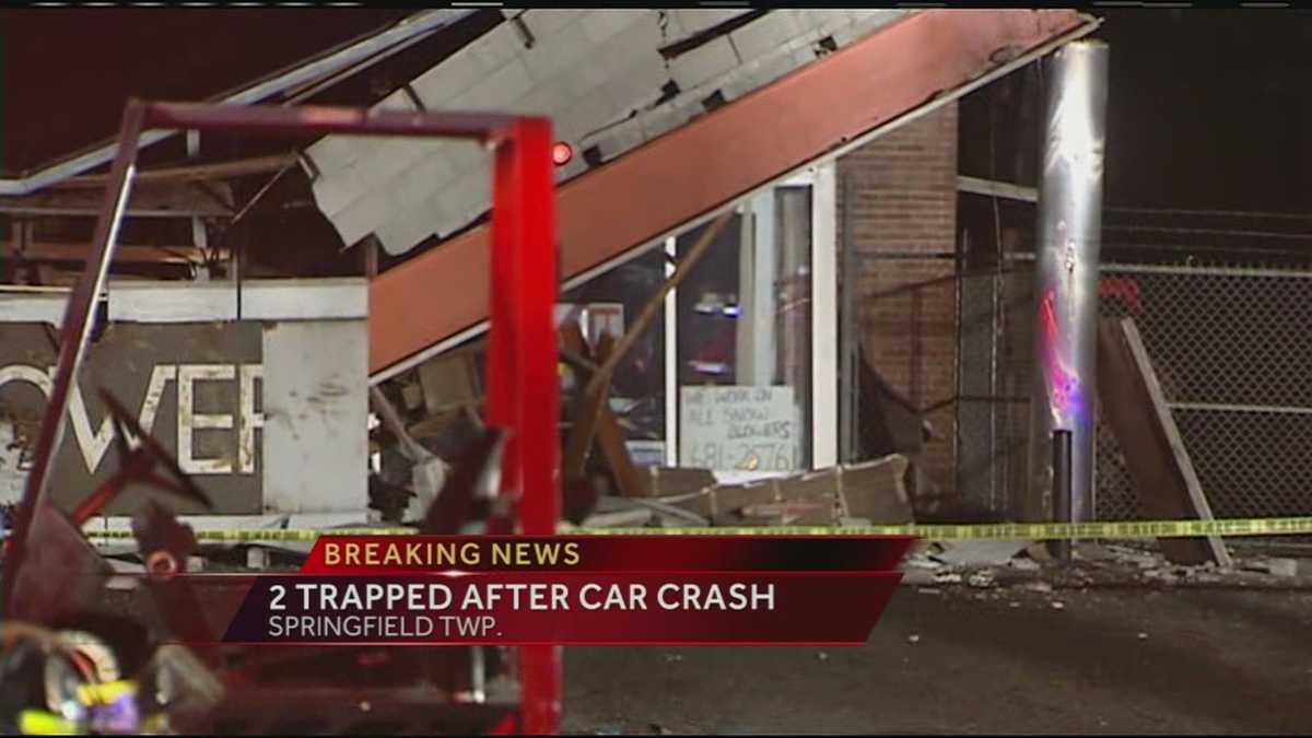 Police: 2 trapped after vehicle crashes into building in Springfield Twp.