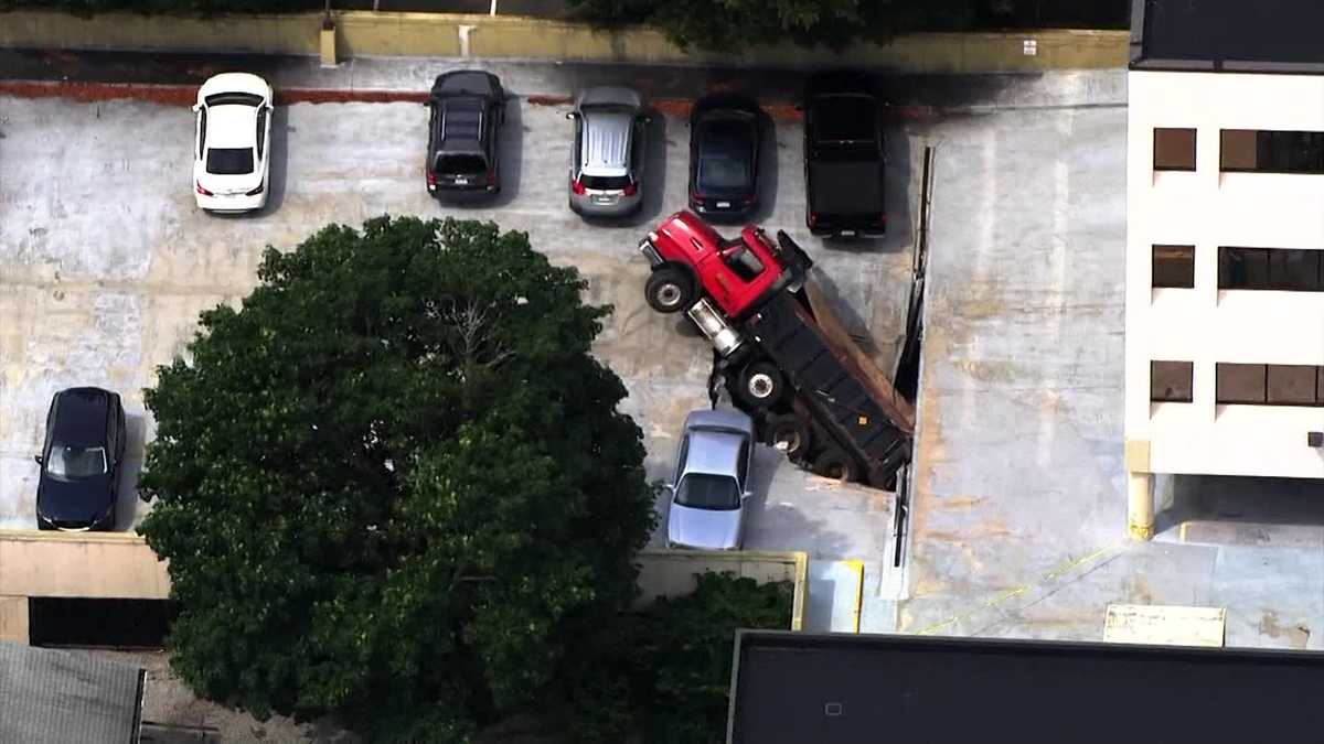 Dump truck falls through upper level of Quincy parking garage