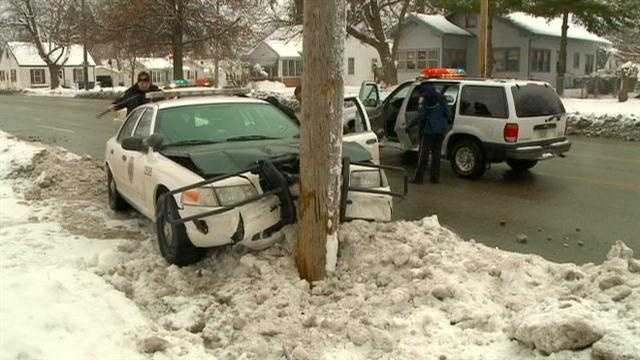 Police car slams into utility pole