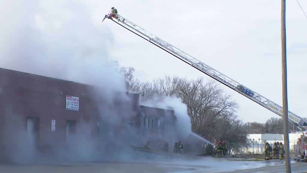 Omaha firefighters working to extinguish hot spots at warehouse fire - KETV