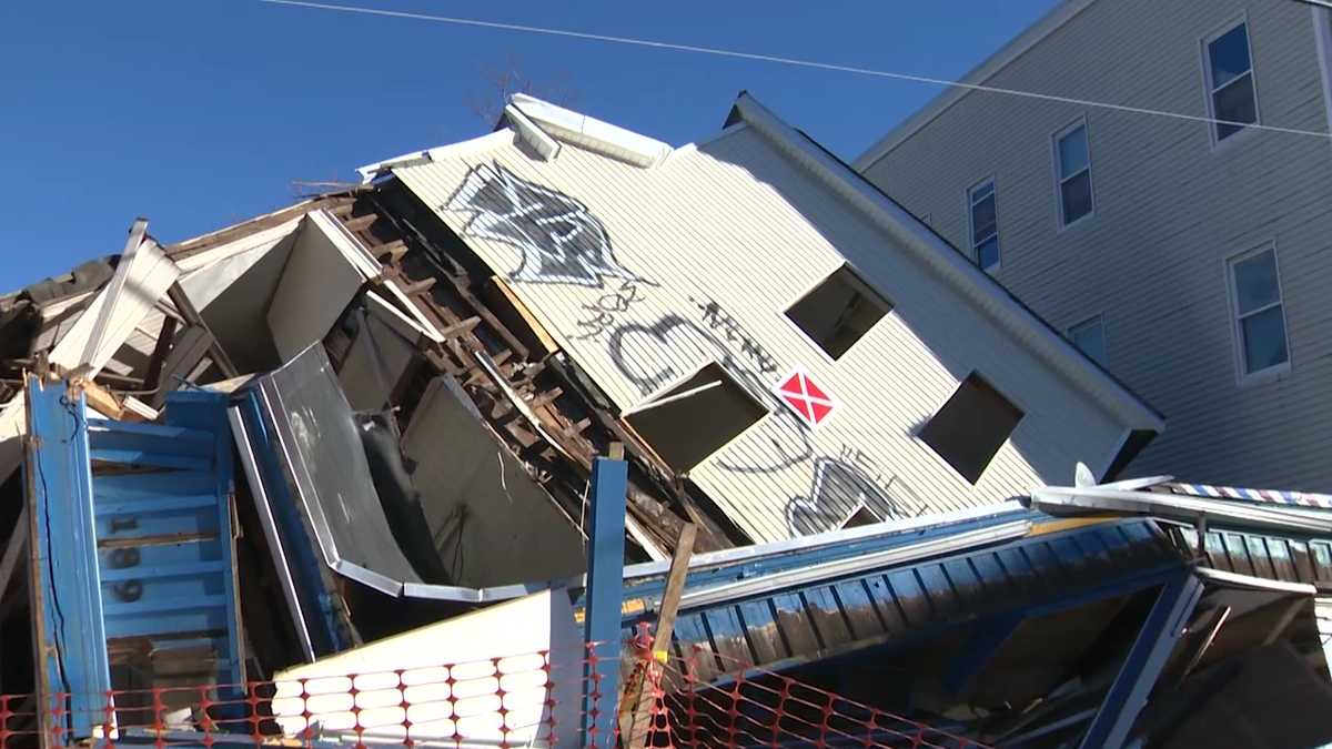 Multi-story apartment building undergoing demolition collapses