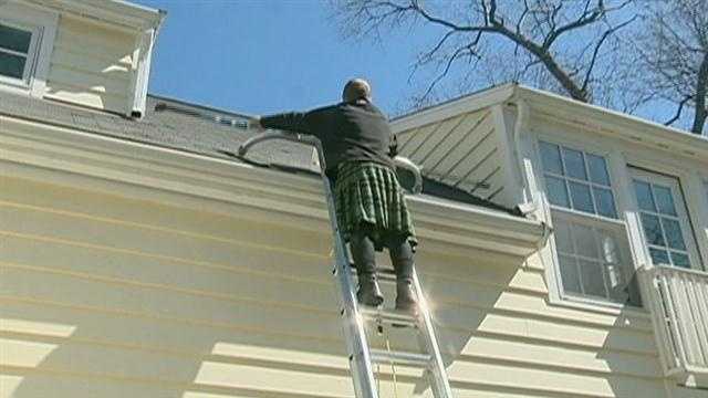 Men in kilts wash windows, clean gutters.