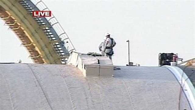 Crews patch building's roof