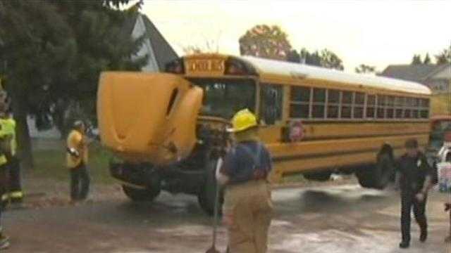 Car collides head-on with school bus carrying students