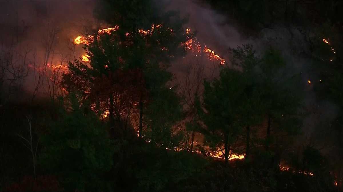 Massachusetts wildfires singe homes, jump fire lines