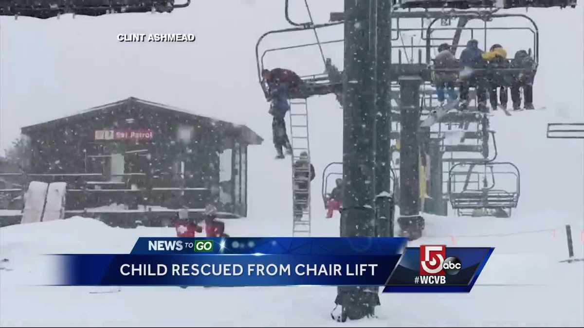 Young Skier Dangles From Chair Lift