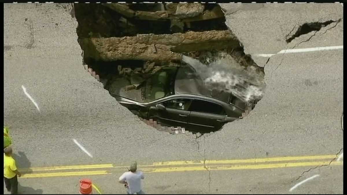 Massive sinkhole swallows woman inside her car