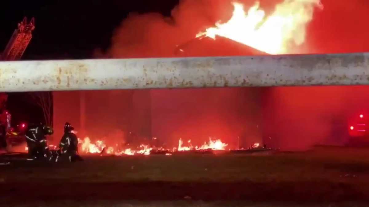 Dramatic footage captures the moment a burning building partially ...