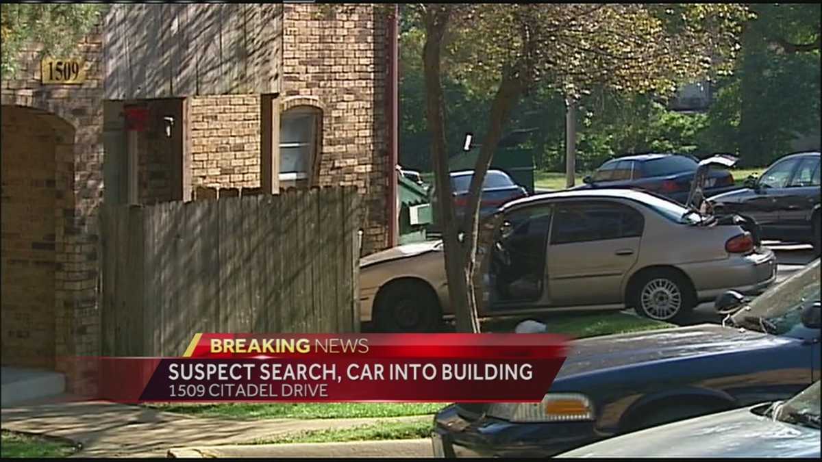Police seek driver after car plows into apartment building