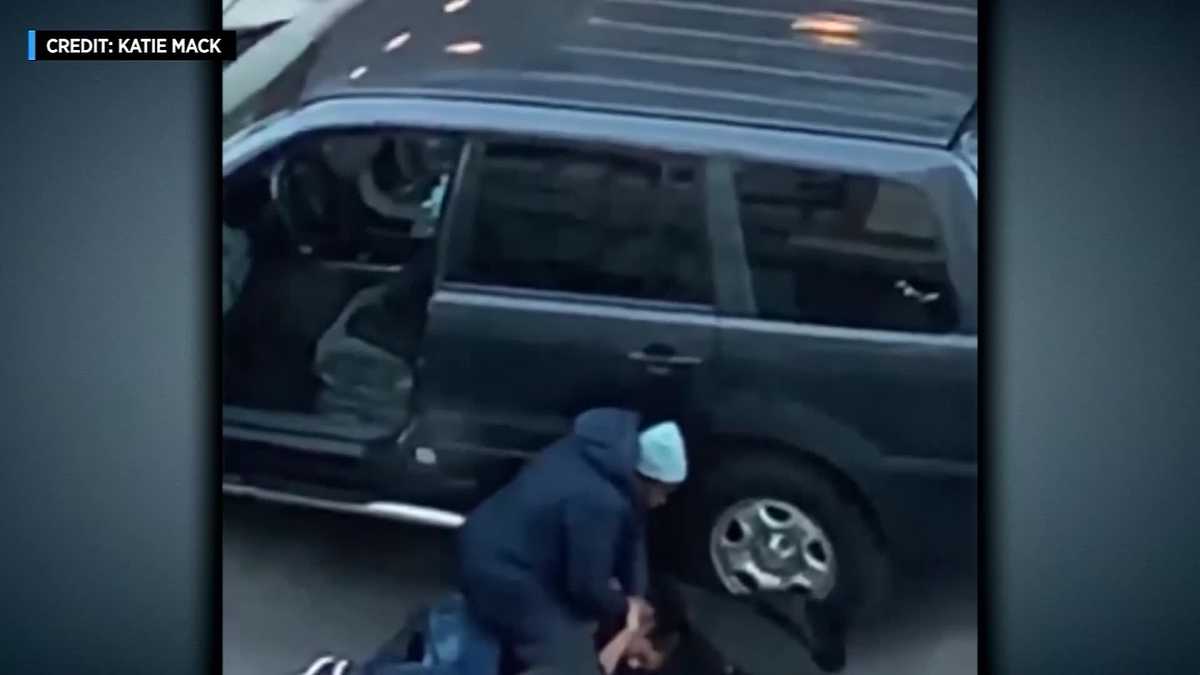 Mom caught on camera sitting on attempted car thief refusing to let him go