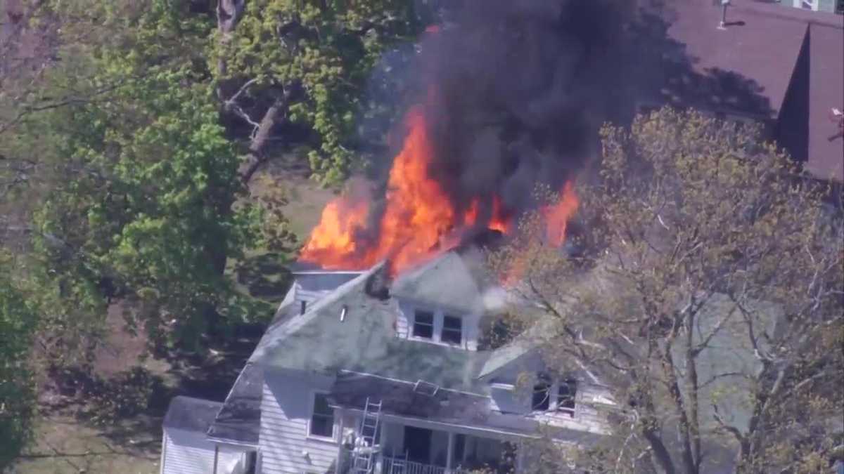 Firefighters face flames, heavy smoke at burning home in Lowell
