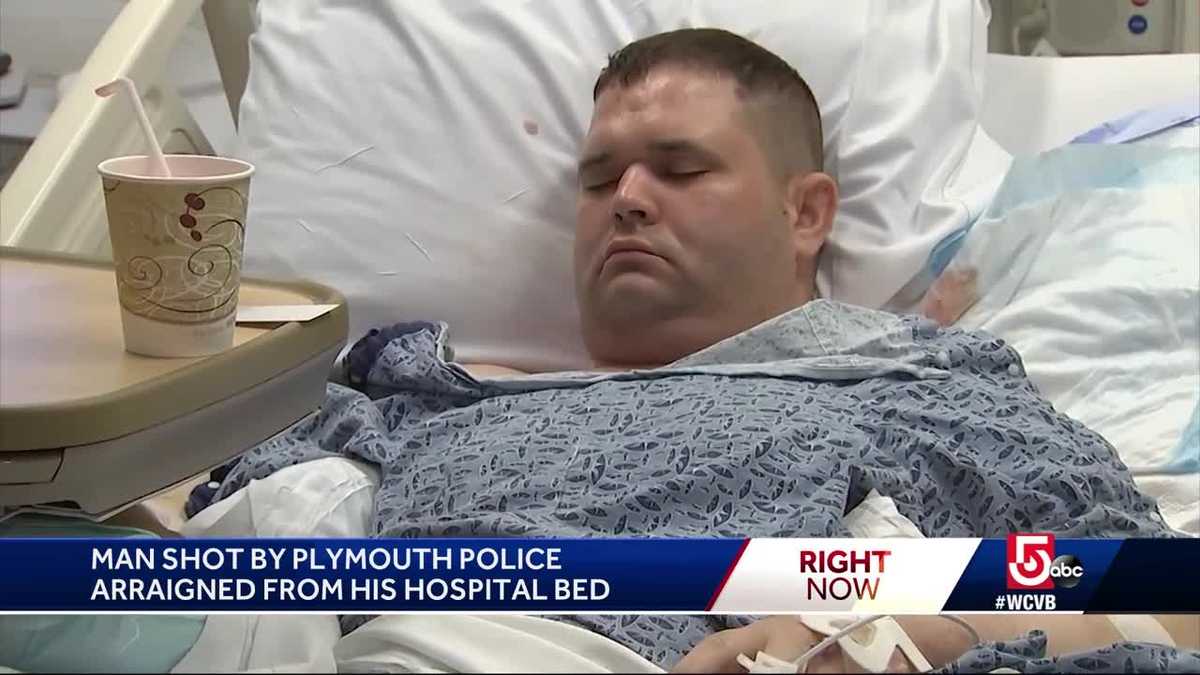 Man who shot at police arraigned from hospital bed