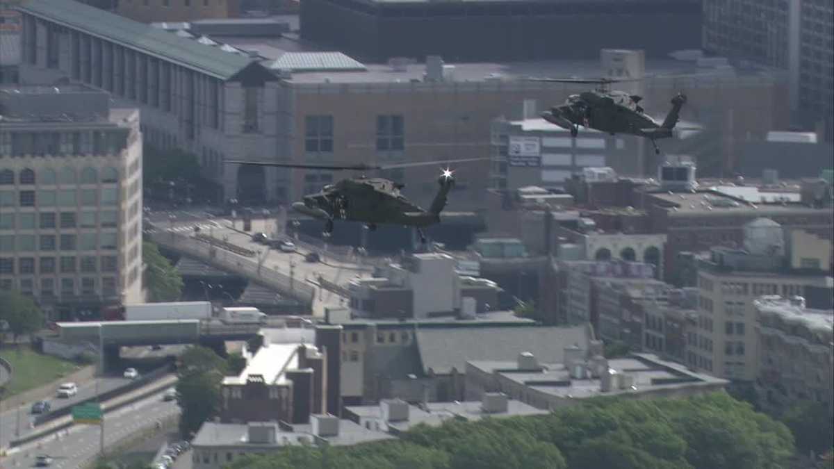 Black Hawk helicopters fly over Boston Marathon route