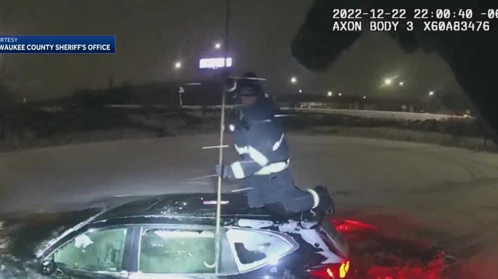 Video: rescue crews save woman from car in pond