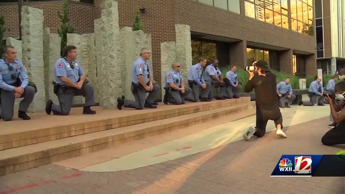 Raleigh police officers kneel in support of protesters