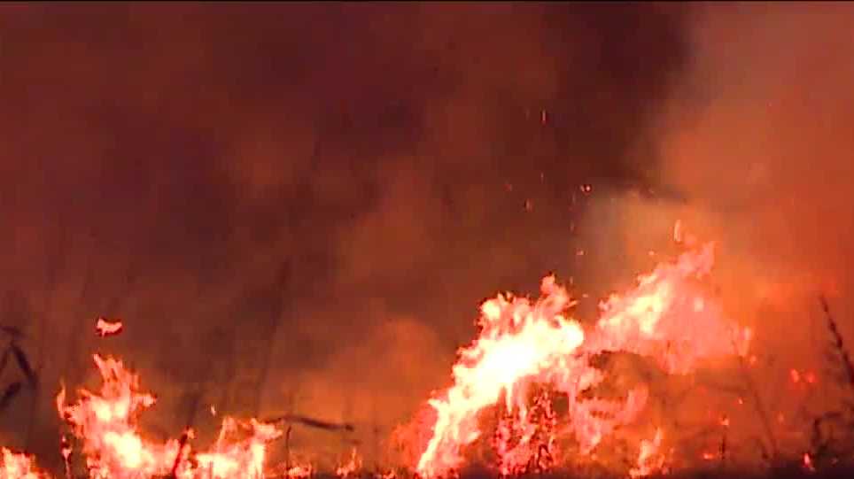 Dozens of hay bales fuel Moore grassfire early Friday morning