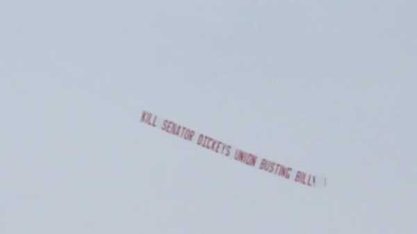 opponents of 'union busting bill' fly message above iowa statehouse