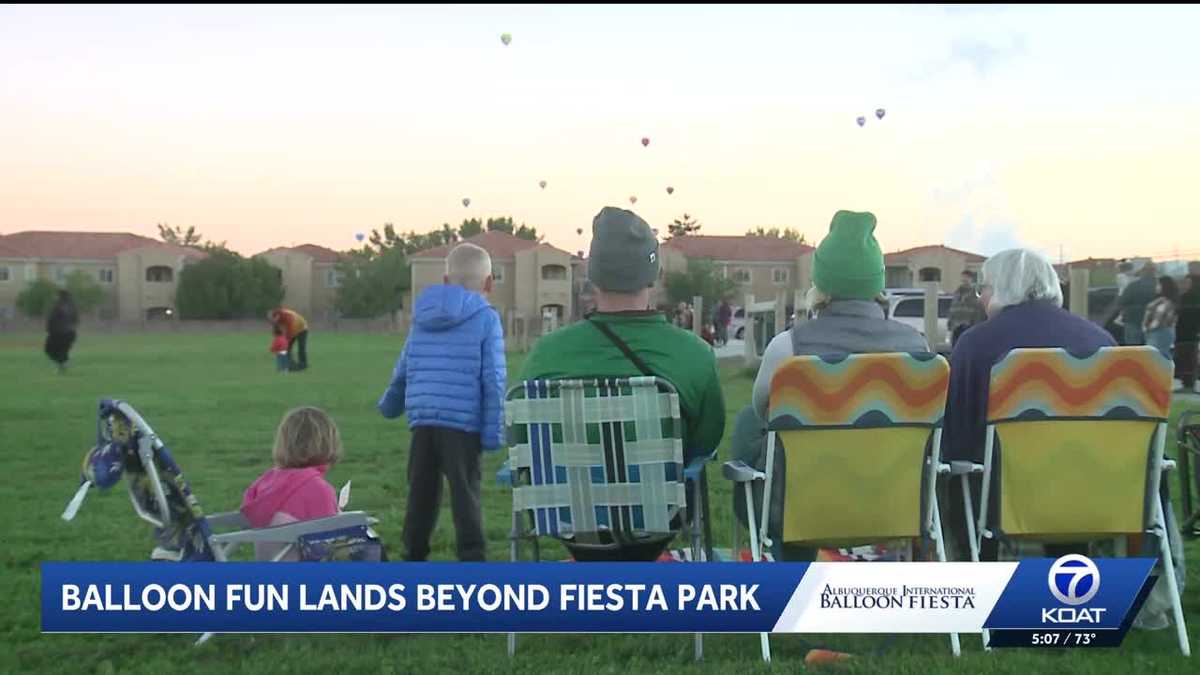 Families chase balloons at Vista Del Norte Park during Albuquerque’s Balloon Fiesta