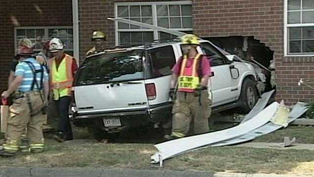 SUV slams into apartment building