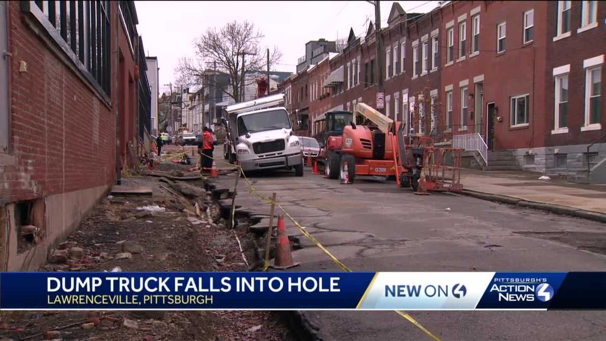 Dump truck falls into hole in Pittsburgh's Lawrenceville neighborhood