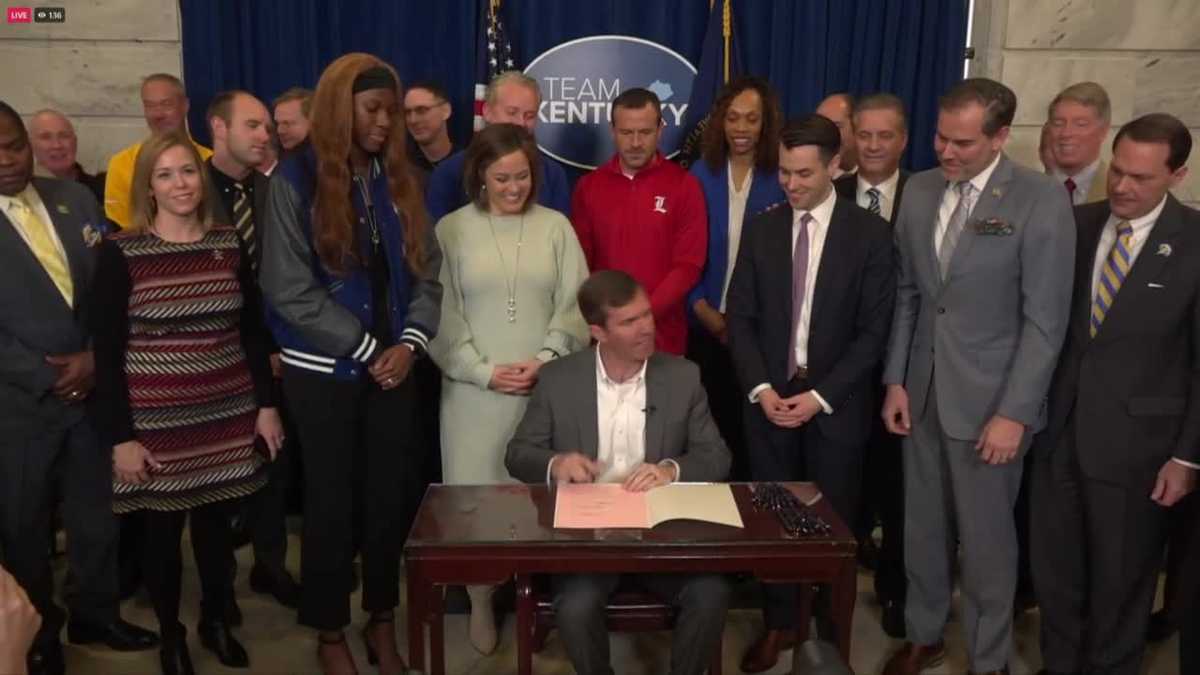 Beshear signals NIL bill into regulation surrounded by college coaches