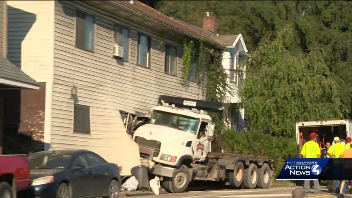 Dump truck crashes into apartment building in Crescent Township
