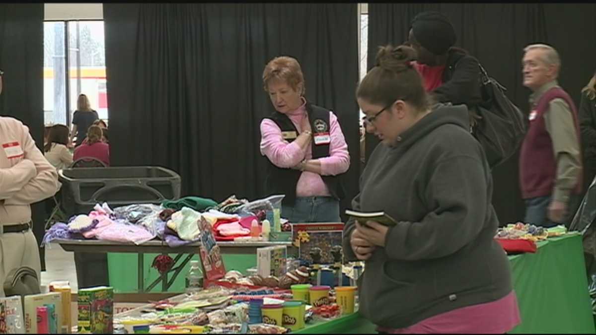 Parents select toys at Salvation Army Toy Shop