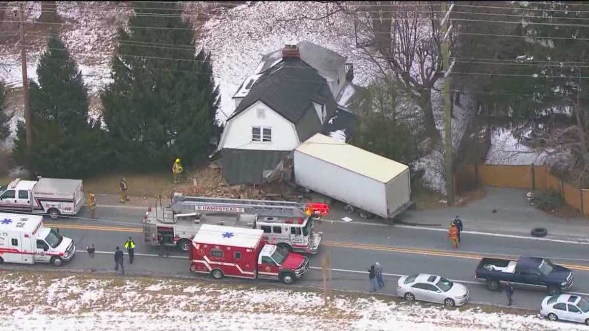 Box truck hits house after colliding with car